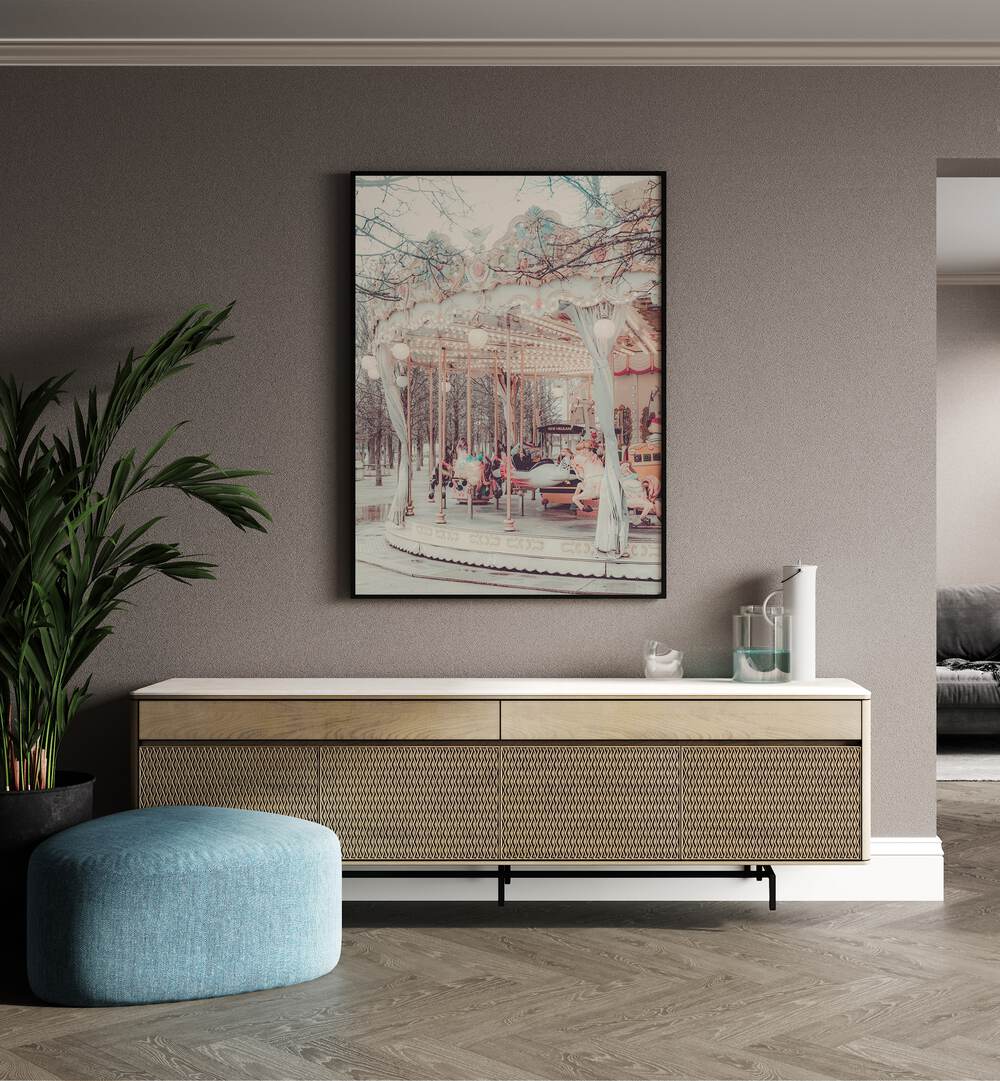 Paris Carousel ii By Grace Digital Art Co Kids Room Prints in Black Plain Frame placed on a wall behind a console table, beside a plant