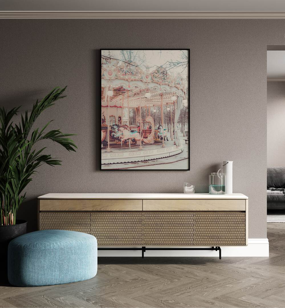 Paris Carousel iii By Grace Digital Art Co Kids Room Prints in Black Plain Frame placed on a wall behind a console table, and a plant