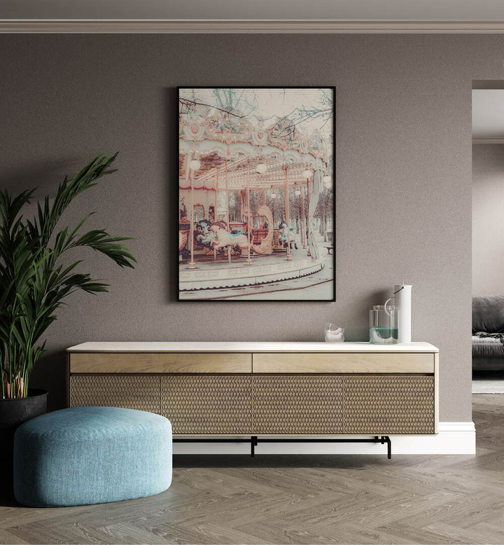 Paris Carousel iii By Grace Digital Art Co Kids Room Prints in Black Plain Frame placed on a wall behind a console table, and a plant