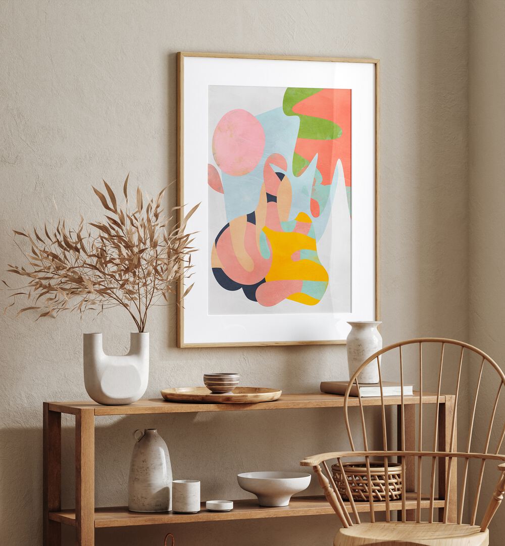 Pastel Cut Out By Ana Rut Bre Abstract Art Abstract Wall Art in Oak Wood Frame With Mount placed on a wall behind a table