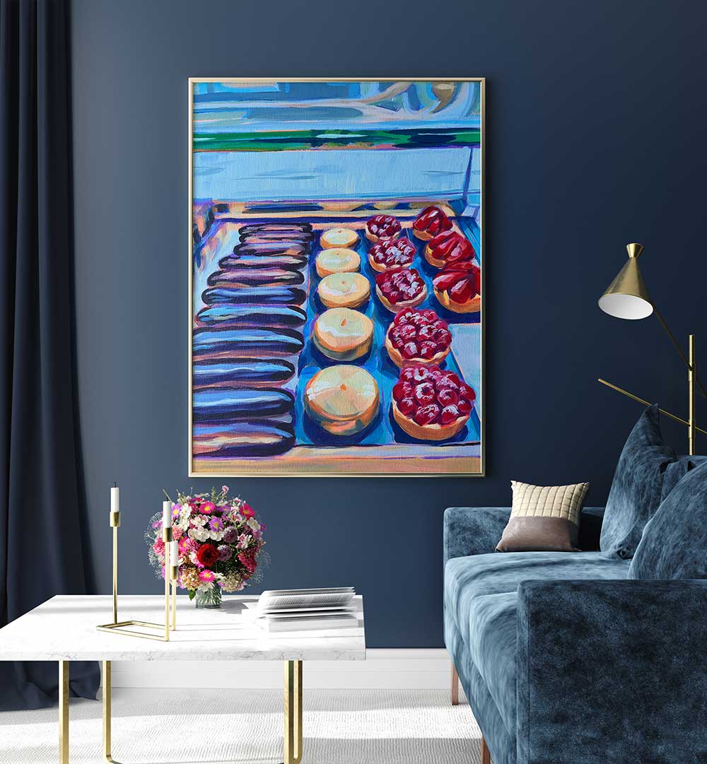 PÂTISSERIE , KITCHEN POSTERS showing framed colorful pastry prints above navy sofa in a modern living room