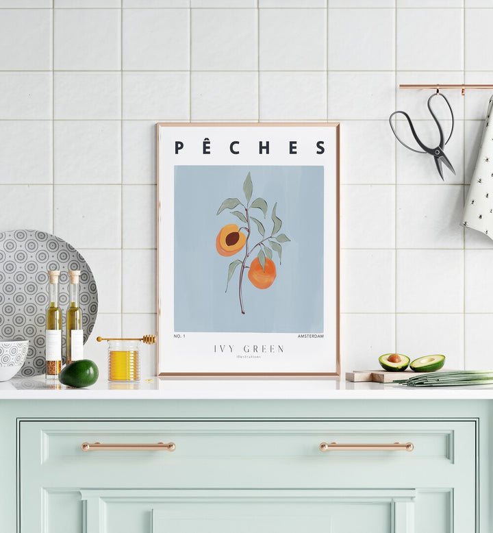 Peaches By Ivy Green Kitchen Art Prints in Oak Wood Plain Frame on a kitchen counter beside avocados for kitchen area 