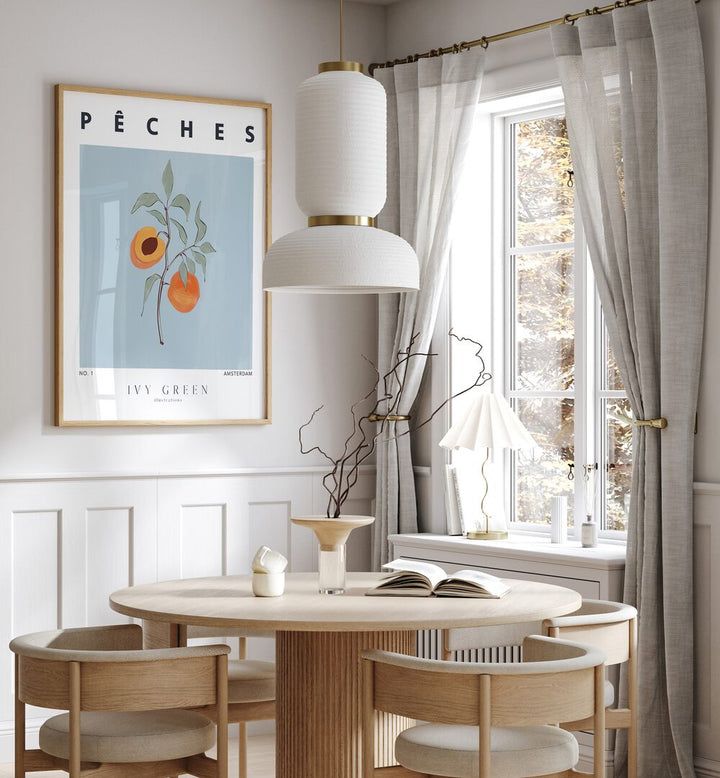 Peaches By Ivy Green Kitchen Art Prints in Oak Wood Plain Frame on a white wall behind a dining table beside a window for dining area