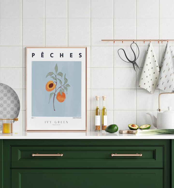 Peaches By Ivy Green Kitchen Art Prints in Oak Wood Plain Frame on a kitchen counter beside a plate for kitchen area