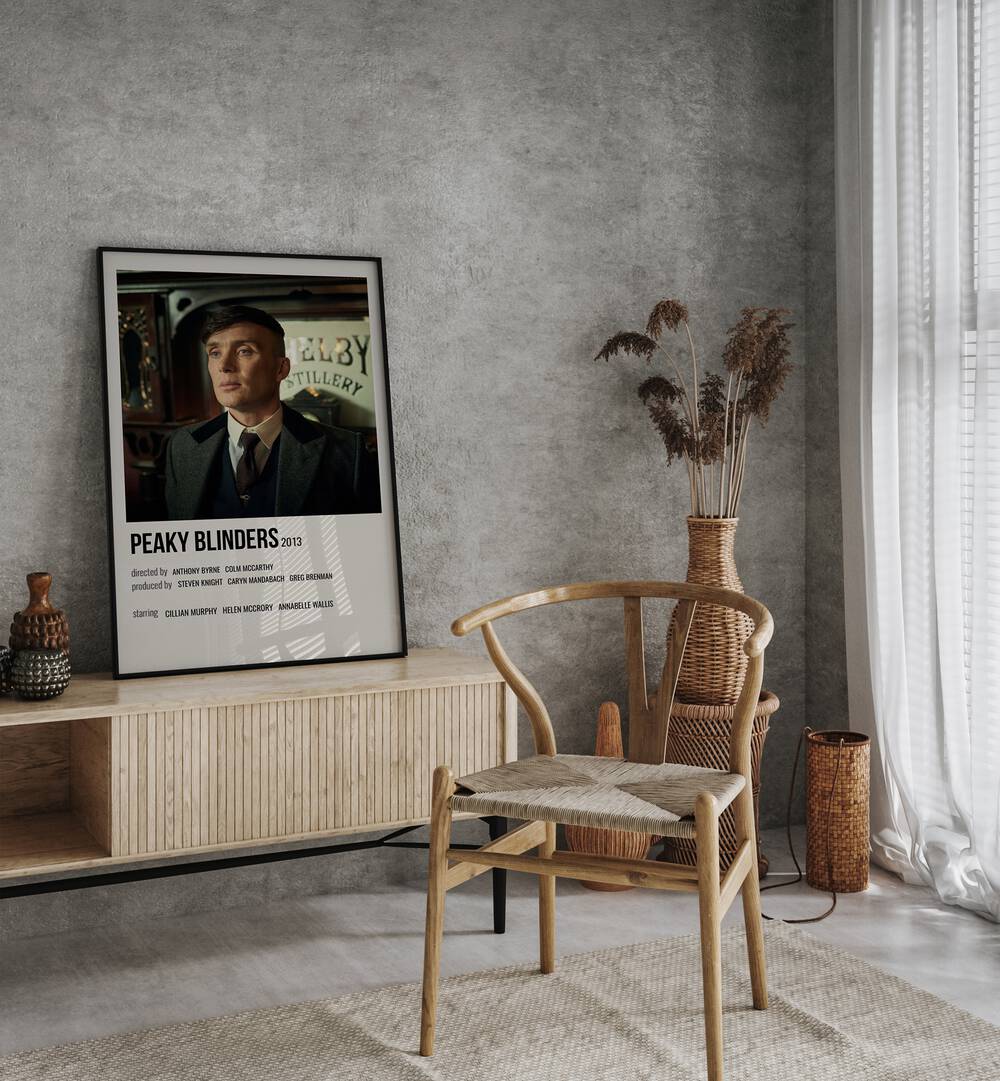 Peaky Blinders 2013 Iv Movie Posters in Black Plain Frame placed on a table beside oakwood chair