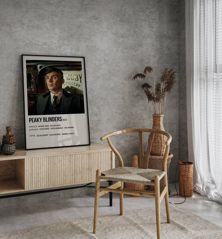 Peaky Blinders 2013 Iv Movie Posters in Black Plain Frame placed on a table beside oakwood chair
