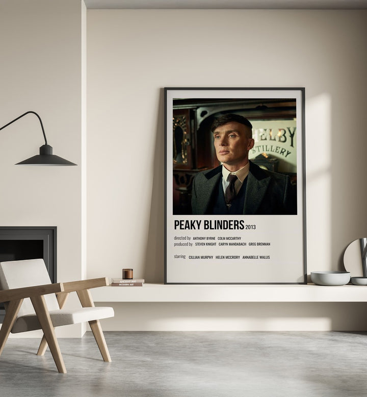Peaky Blinders 2013 Iv Movie Posters in Black Plain Frame place on a wall behind a chair beside lamp