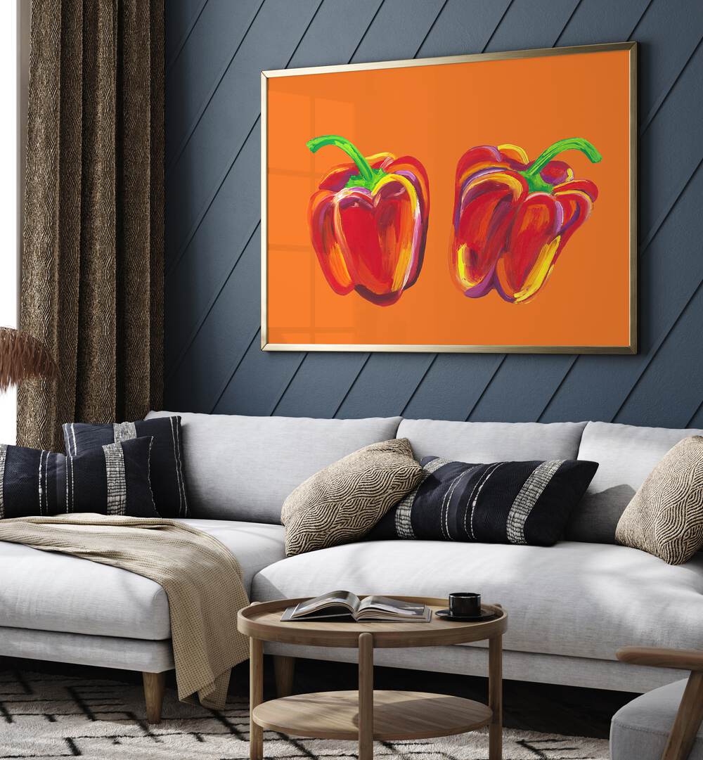 Peppers On Orange by Alice Straker Kitchen Posters Kitchen Art Prints in Gold Plain Frame placed on a living room wall behind a sofa