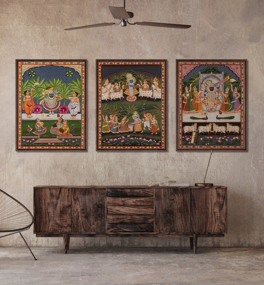 Pichwai Artworks Set Of 3 Paintings in Black Plain Frame placed on a  wall behind a console table