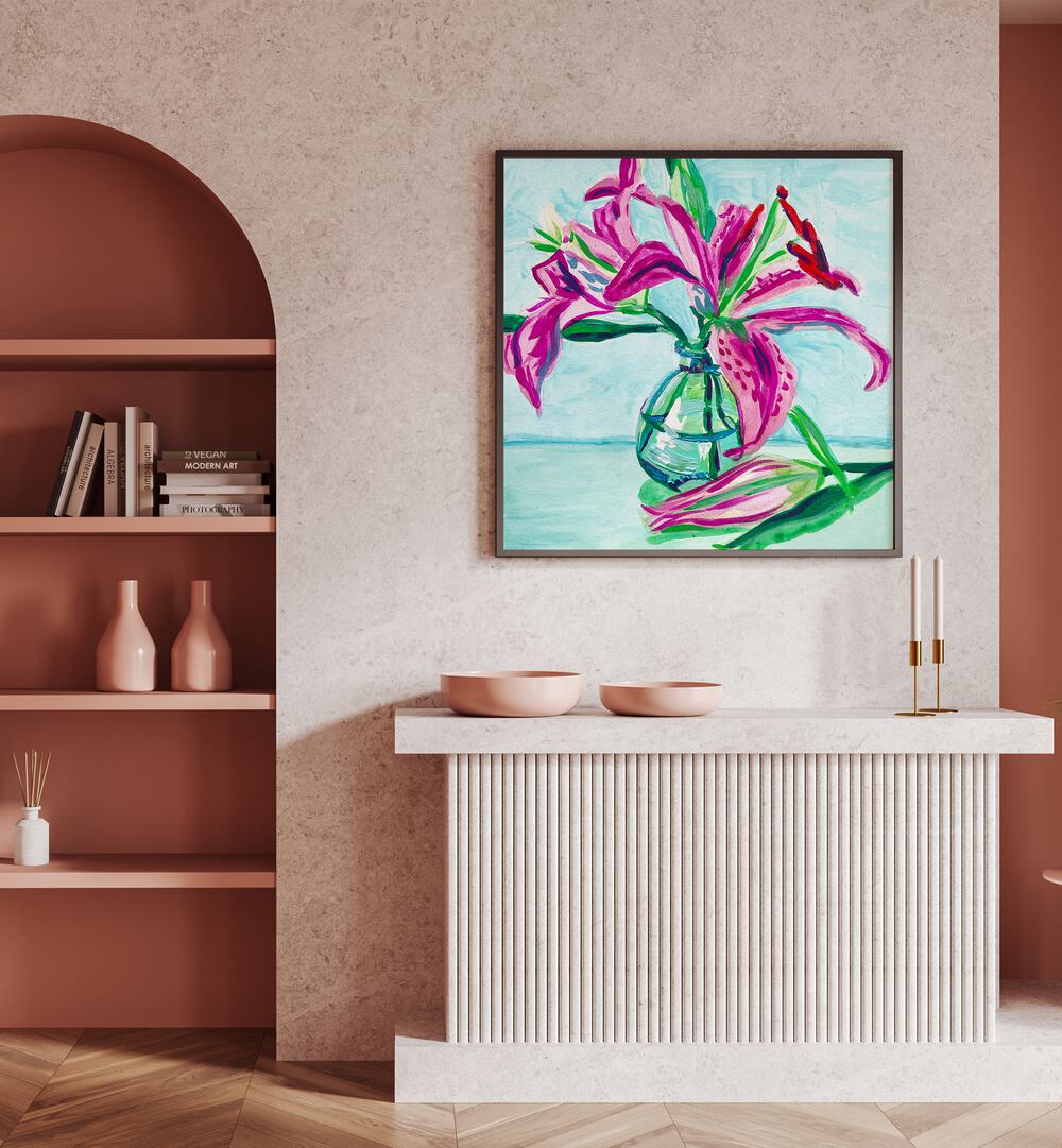 Pink Lilies By Key And Sea Creative Botanical Room Art in Black Plain Frame on pink wall above a table