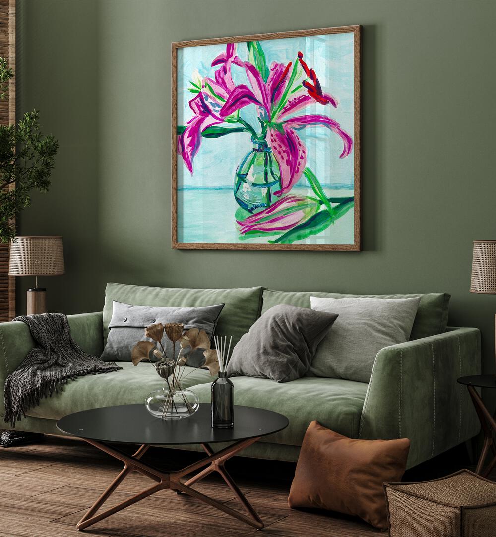 Pink Lilies By Key And Sea Creative Botanical Room Art in Oak Wood Plain Frame behind a sofa for a green wall