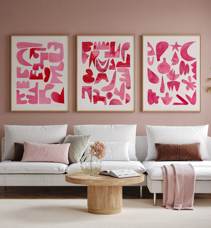 Pink Puzzles Set Set Of 3 Paintings in Oak Wood Plain Frame placed on a wall behind a white sofa for living room