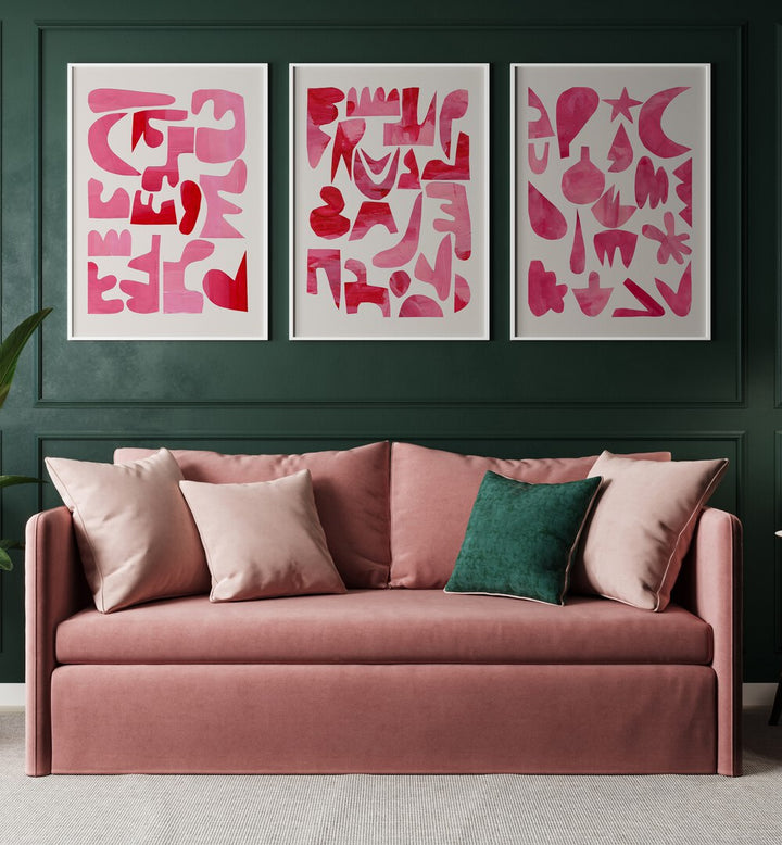 Pink Puzzles Set Set Of 3 Paintings in White Plain Frame placed on a green wall behind a pink