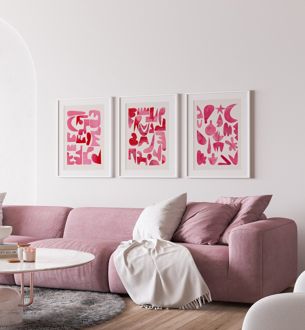 Pink Puzzles Set Set Of 3 Paintings in White Frame With Mount placed on a white wall behind a pink sofa for living room