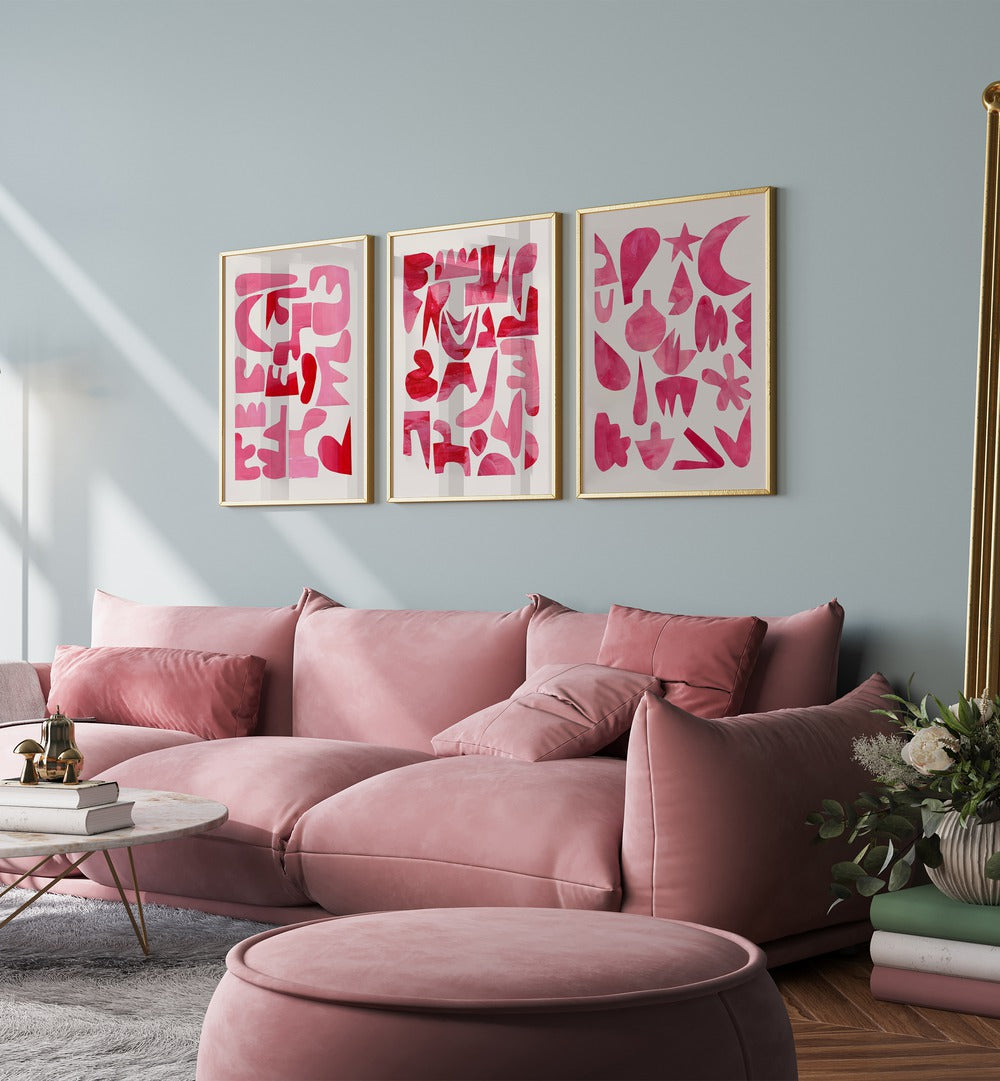 Pink Puzzles Set Set Of 3 Paintings in Gold Plain Frame placed on a green wall behind a pink sofa for living room