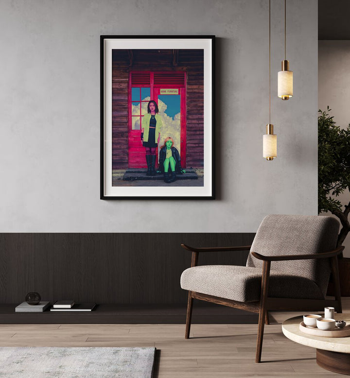 Pink and Green By Cosmo Zach Surreal Art Prints Surrealism in Black Frame With Mount placed on a wall beside a chair