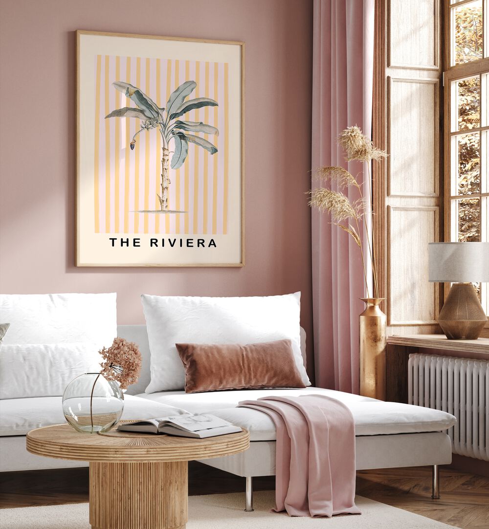 Pink and Yellow Palm Tree By Grace Digital Art Co Beach Prints in Oak Wood Plain Frame placed on a pink wall behind a white sofa