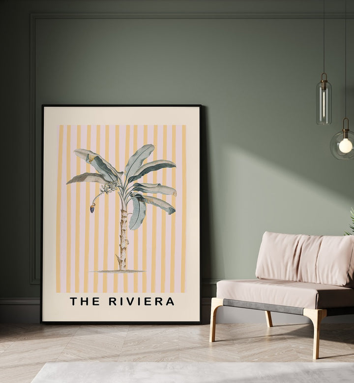 Pink and Yellow Palm Tree By Grace Digital Art Co Beach Prints in Black Plain Frame placed on a floor beside a sofa