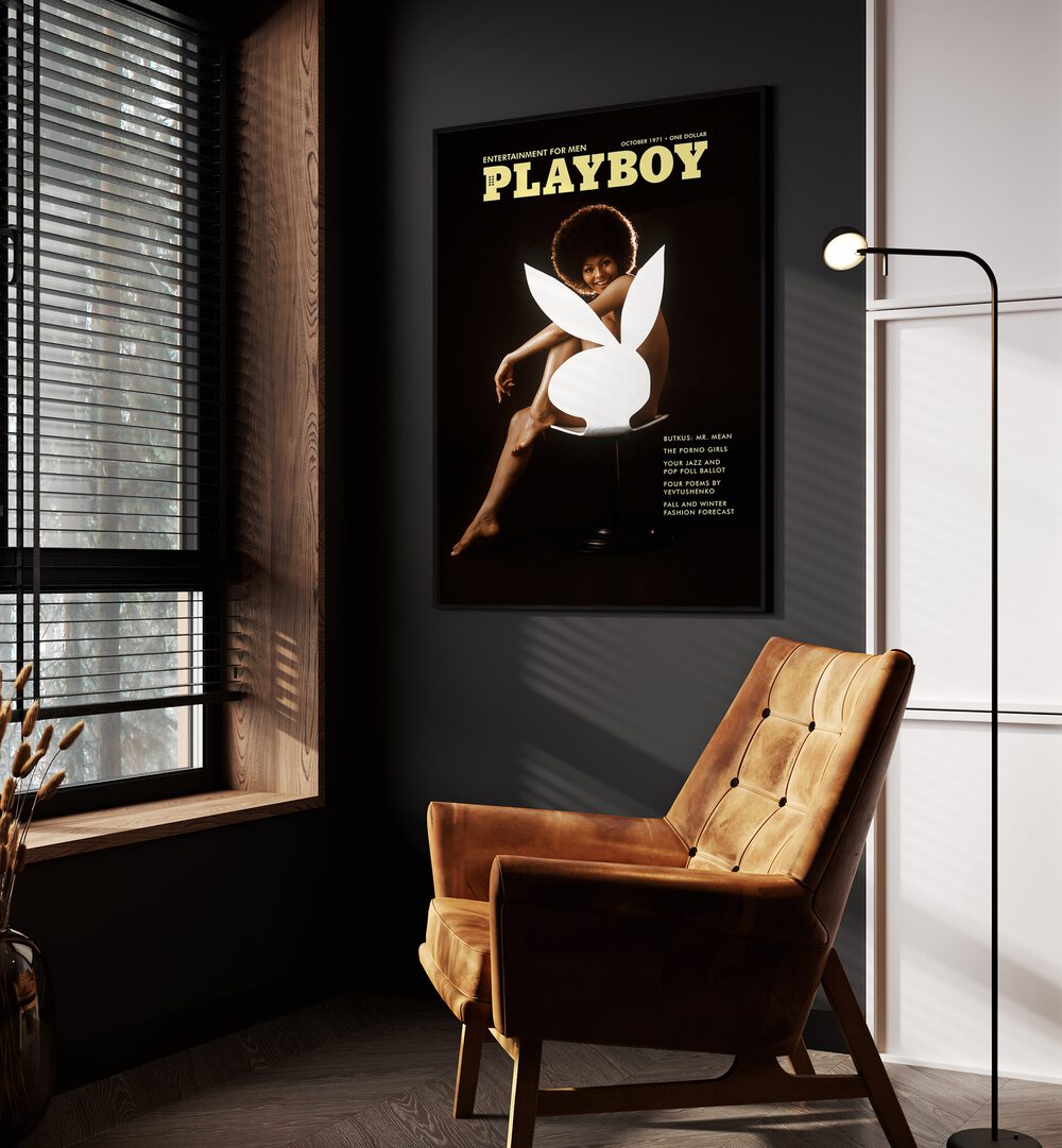 Playboy  Women Illustrations paintings in Black Plain Frame placed on a wall beside an orange sofa