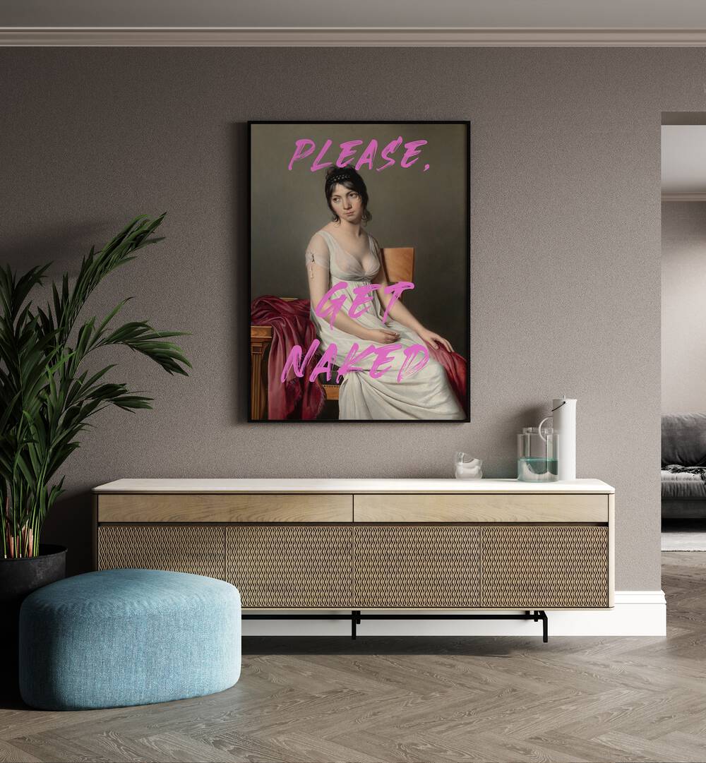 Please Get Naked by the Art Concept Altered Art Prints in Black Plain Frame placed on a wall behind a console table