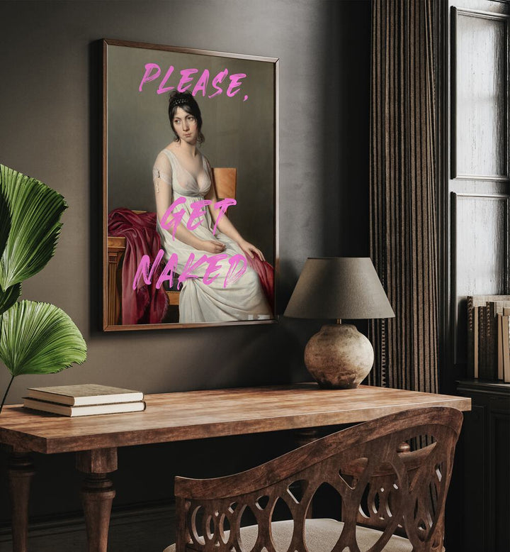 Please Get Naked by the Art Concept Altered Art Prints in Dark Wood Plain Frame placed on a wall above a study table