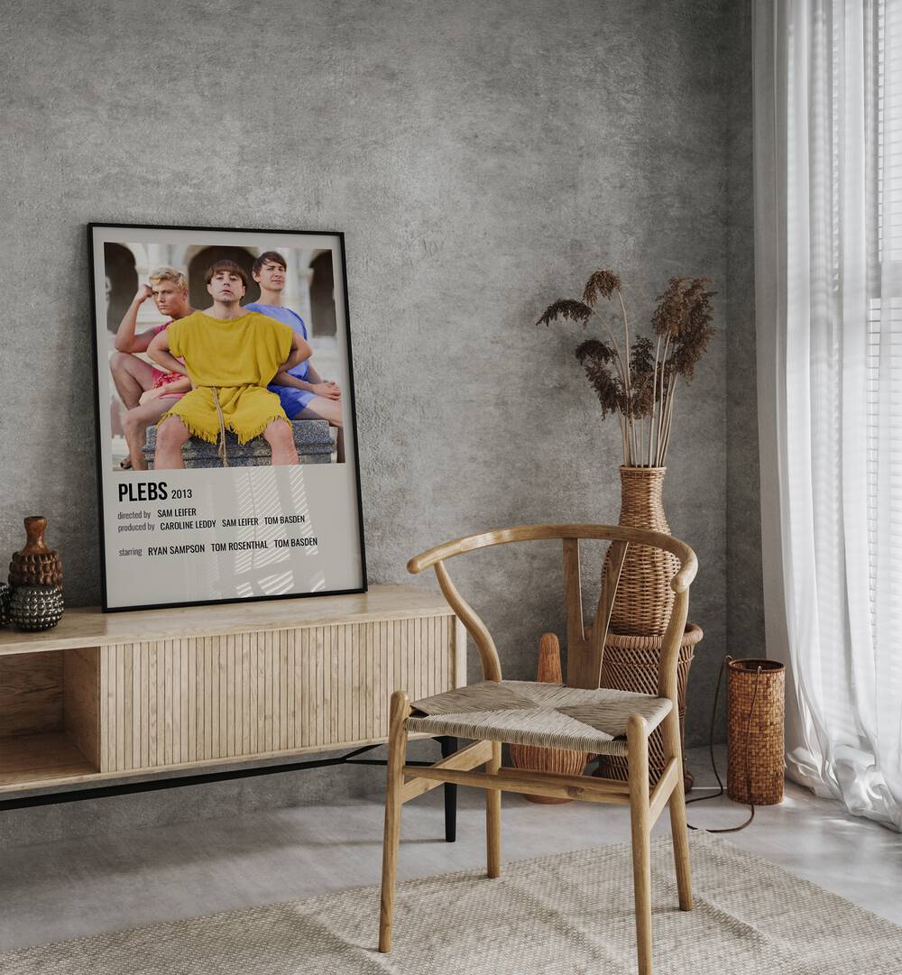 Plebs 2013 Movie Posters in Black Plain Frame placed on a table beside oakwood chair