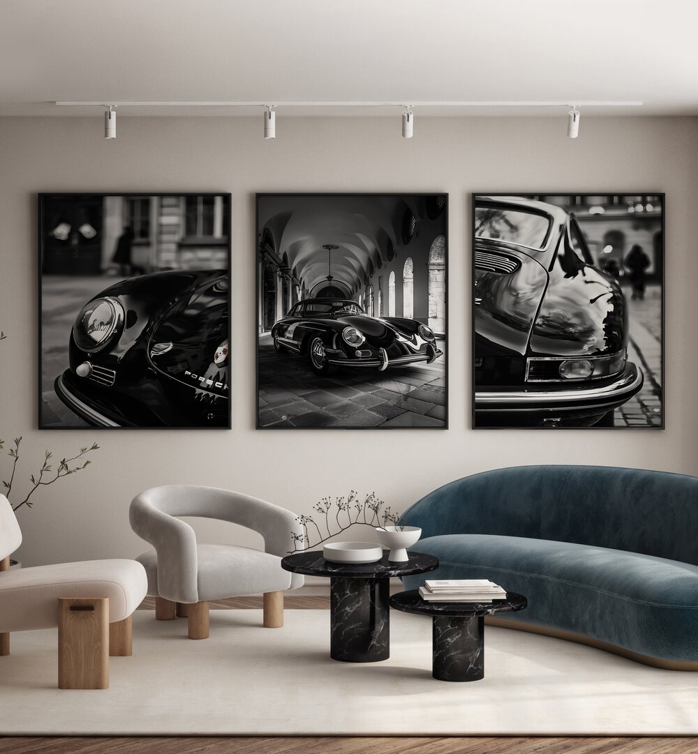 Porsche Set Set Of 3 Paintings in Black Plain Frame placed on a wall behind a blue sofa and a white chair