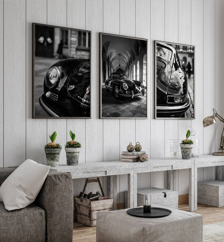 Porsche Set Set Of 3 Paintings in Black Plain Frame placed on a grey wall behind tables, beside a sofa