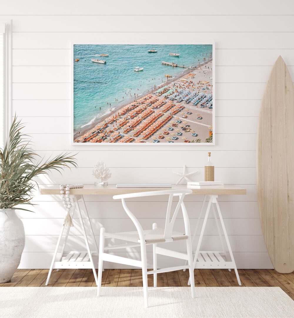 Positano Beach By Grace Digital Art Co Beach Prints in White Plain Frame placed on a wall behind a table