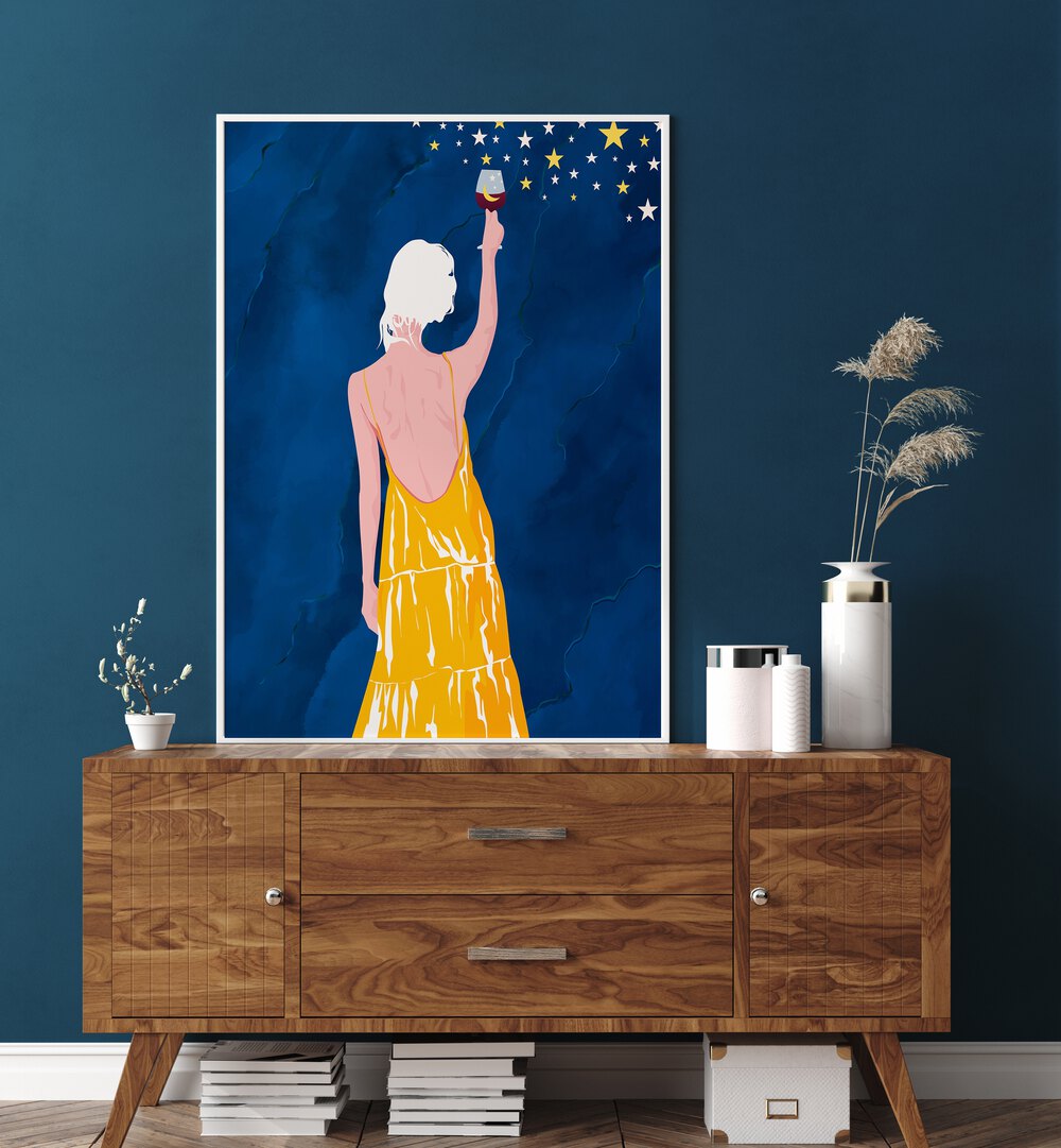 Pour Me Some Magic By Uma Gokhale Woman Illustration Paintings in White Plain Frame above a wooden console table beside  a flower pot