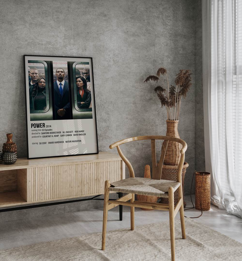 Power 2014 Movie Posters in Black Plain Frame placed on a table beside oakwood chair