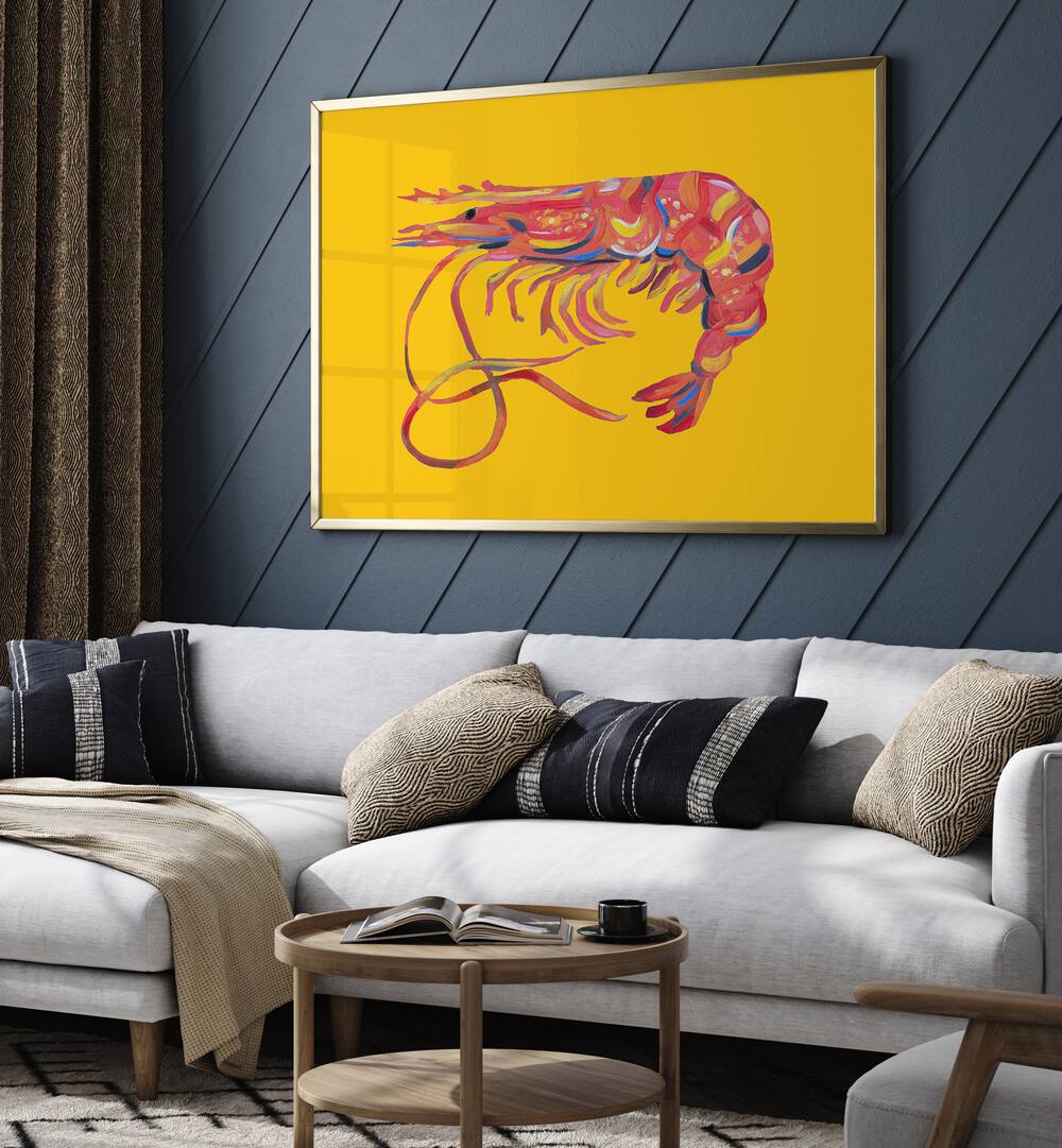 Prawn on Yellow by Alice Straker Cafe Art Prints Cafe Posters in Golden Plain Frame placed on a living room wall behind a white sofa