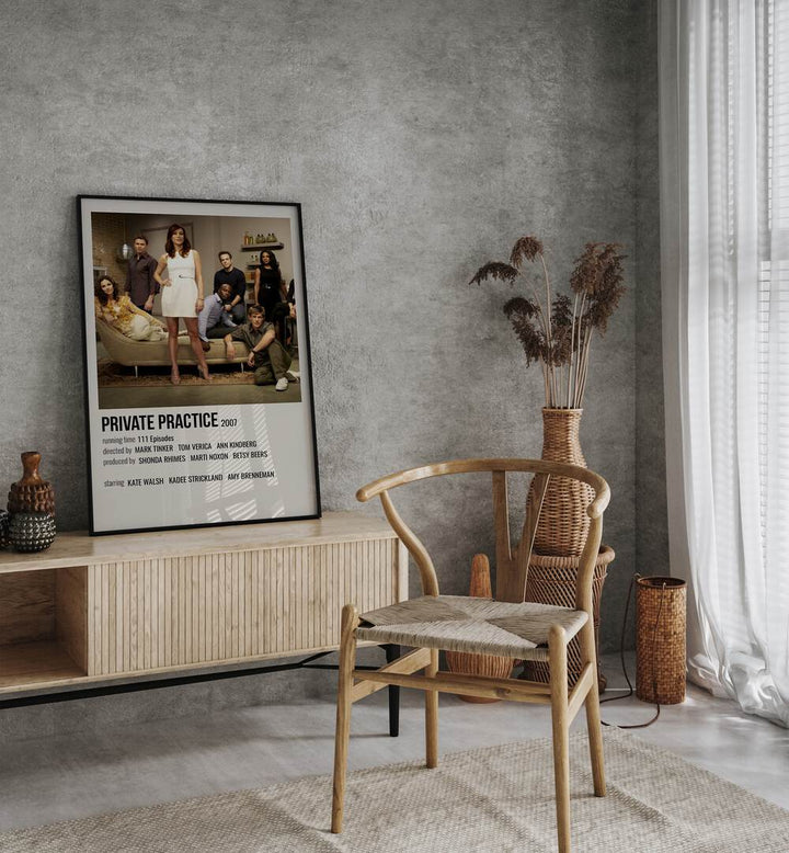 Private Practice 2007 Movie Posters in Black Plain Frame placed on a table beside oakwood chair