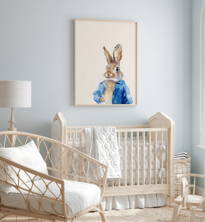 Rabbit In Blue Coat Kids Room Paintings Kids Room Wall Art in Oak Wood Plain Frame placed on a wall in a kids room behind an infant's bed