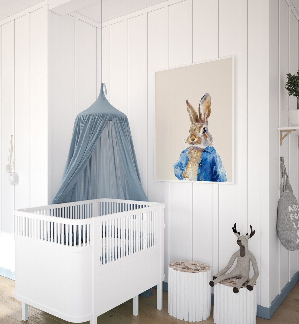 Rabbit In Blue Coat Kids Room Paintings Kids Room Wall Art in White Plain Frame placed on a wall in a kids room beside an infant's bed