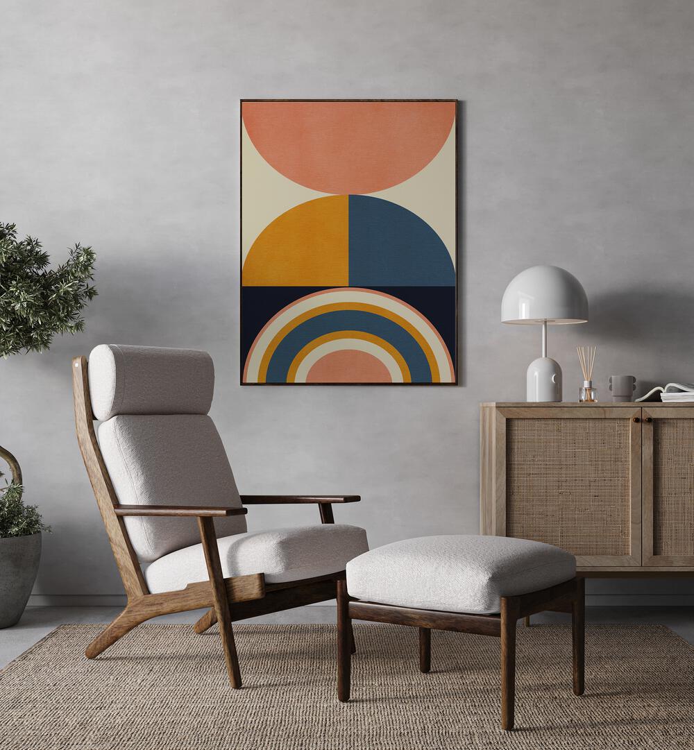 Rainbow Plus Shapes Blue Mustard X By Ana Rut Bre Abstract Art Abstract Wall Art in Black Plain Frame placed on a wall beside a table