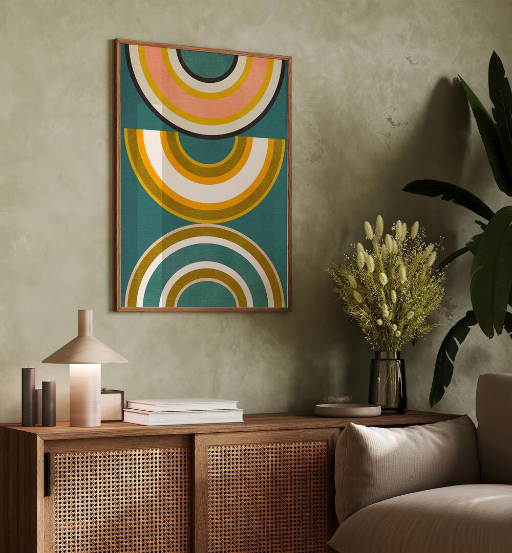 Rainbow Suns V Kopie By Ana Rut Bre Abstract Art Abstract Wall Art in Oak Wood Plain Frame placed on a wall behind a console table