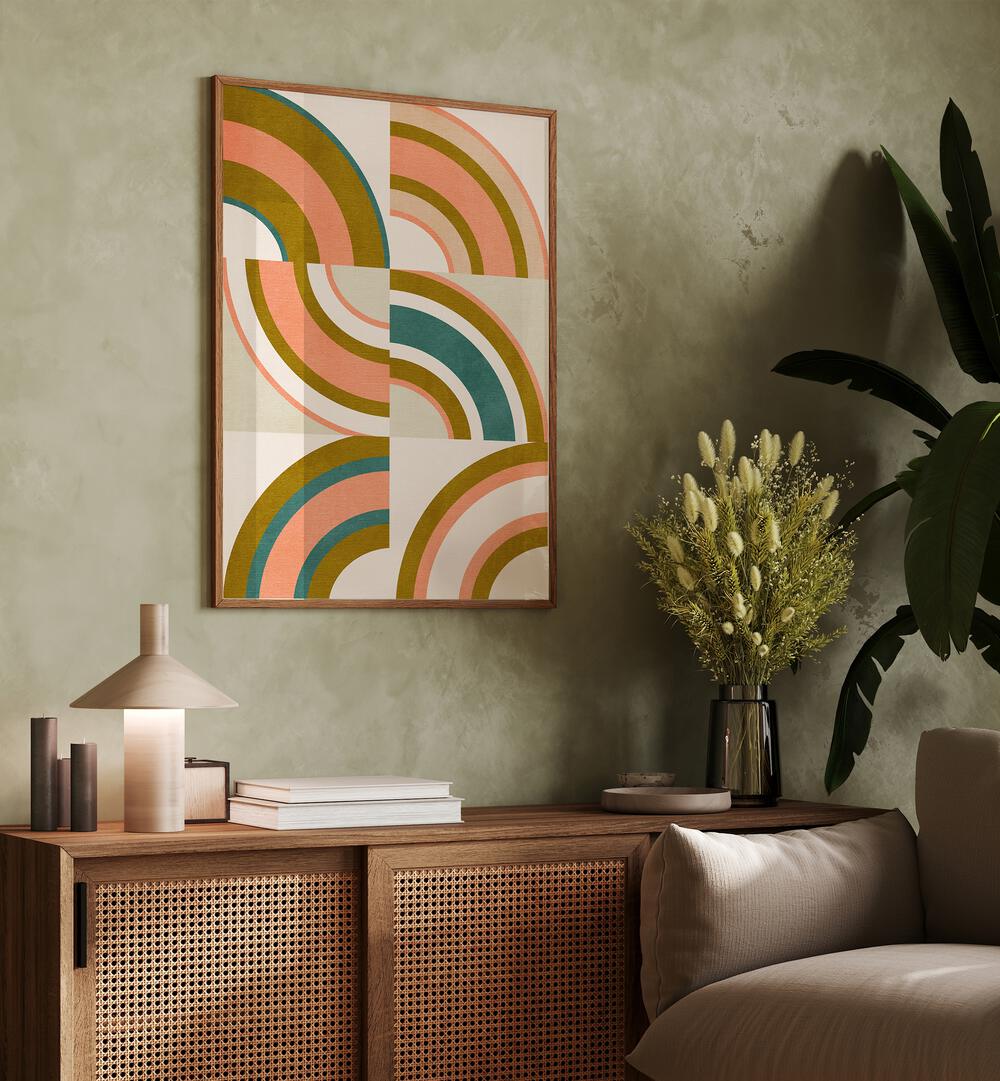 Rainbow Suns x By Ana Rut Bre Abstract Art Abstract Wall Art in Oak Wood Plain Frame placed on a wall behind a table