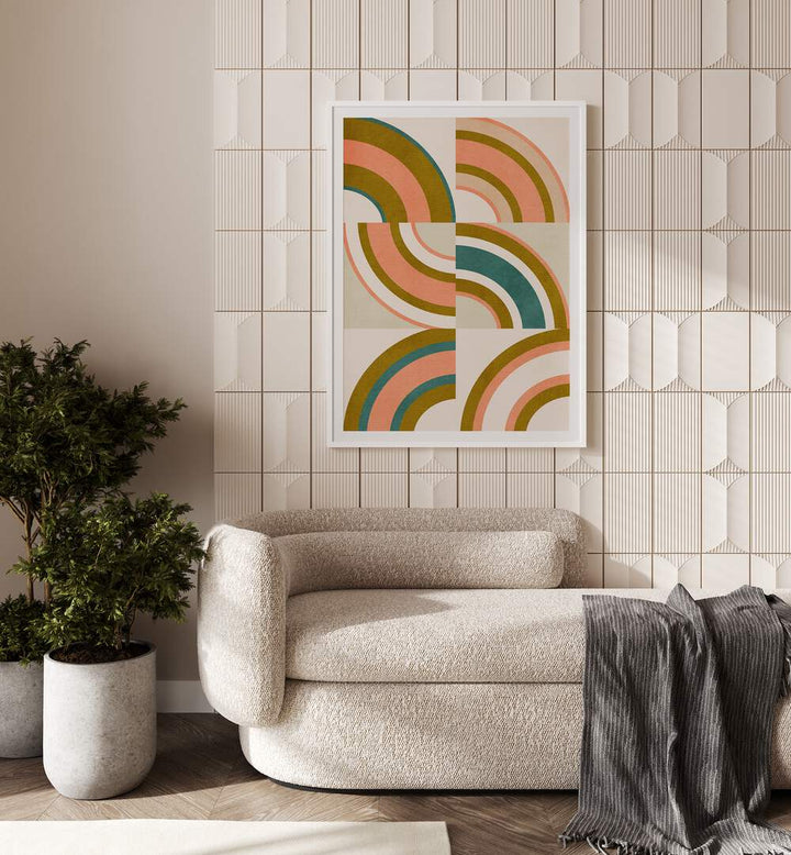 Rainbow Suns x By Ana Rut Bre Abstract Art Abstract Wall Art in White Frame With Mount placed on a wall behind a sofa