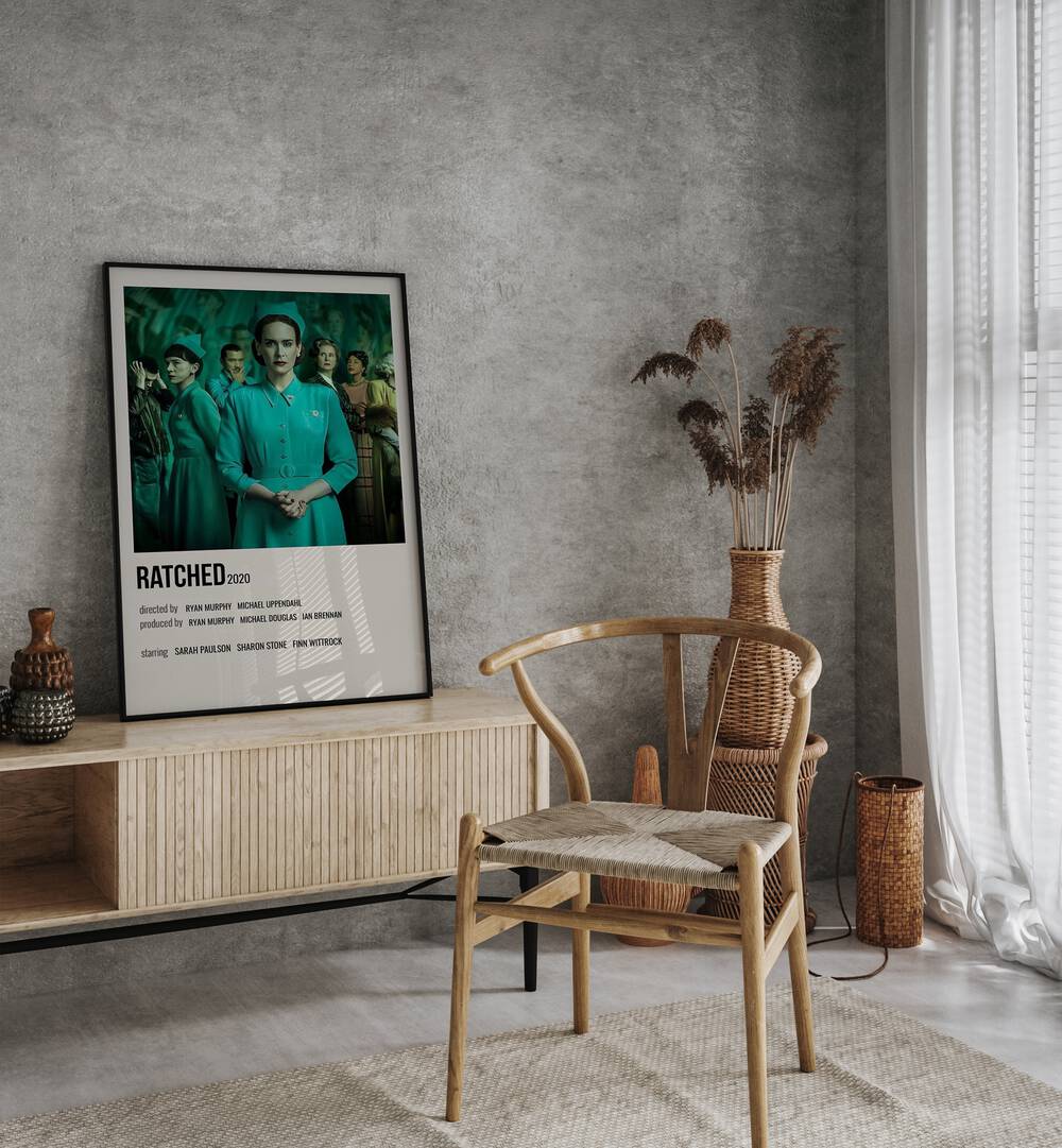 Ratched 2020 Movie Posters in Black Plain Frame placed on a table beside oakwood chair