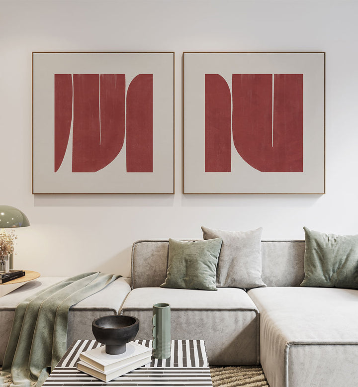 Modern living room with a gray sectional sofa, abstract red art on the wall, and decorative pillows.
