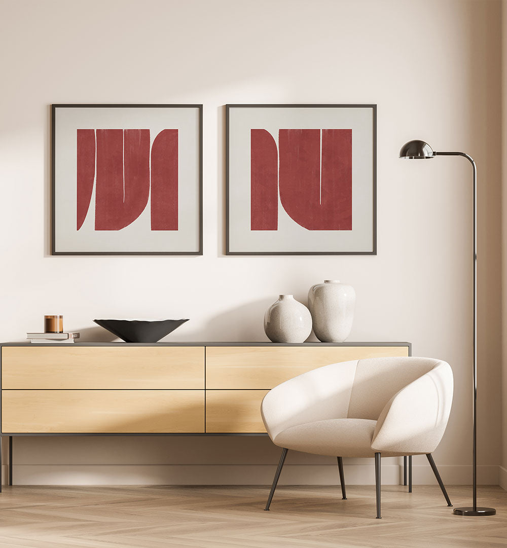 Modern interior with a light wood sideboard, white chair, and abstract red art on a beige wall.