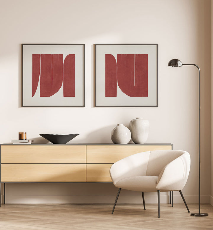 Modern interior with a light wood sideboard, white chair, and abstract red art on a beige wall.