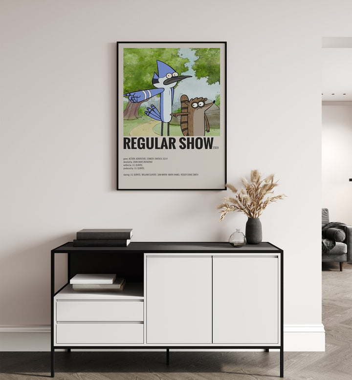 Regular Show Movie Posters in Black Plain Frame placed on a white wall behind a black and white table