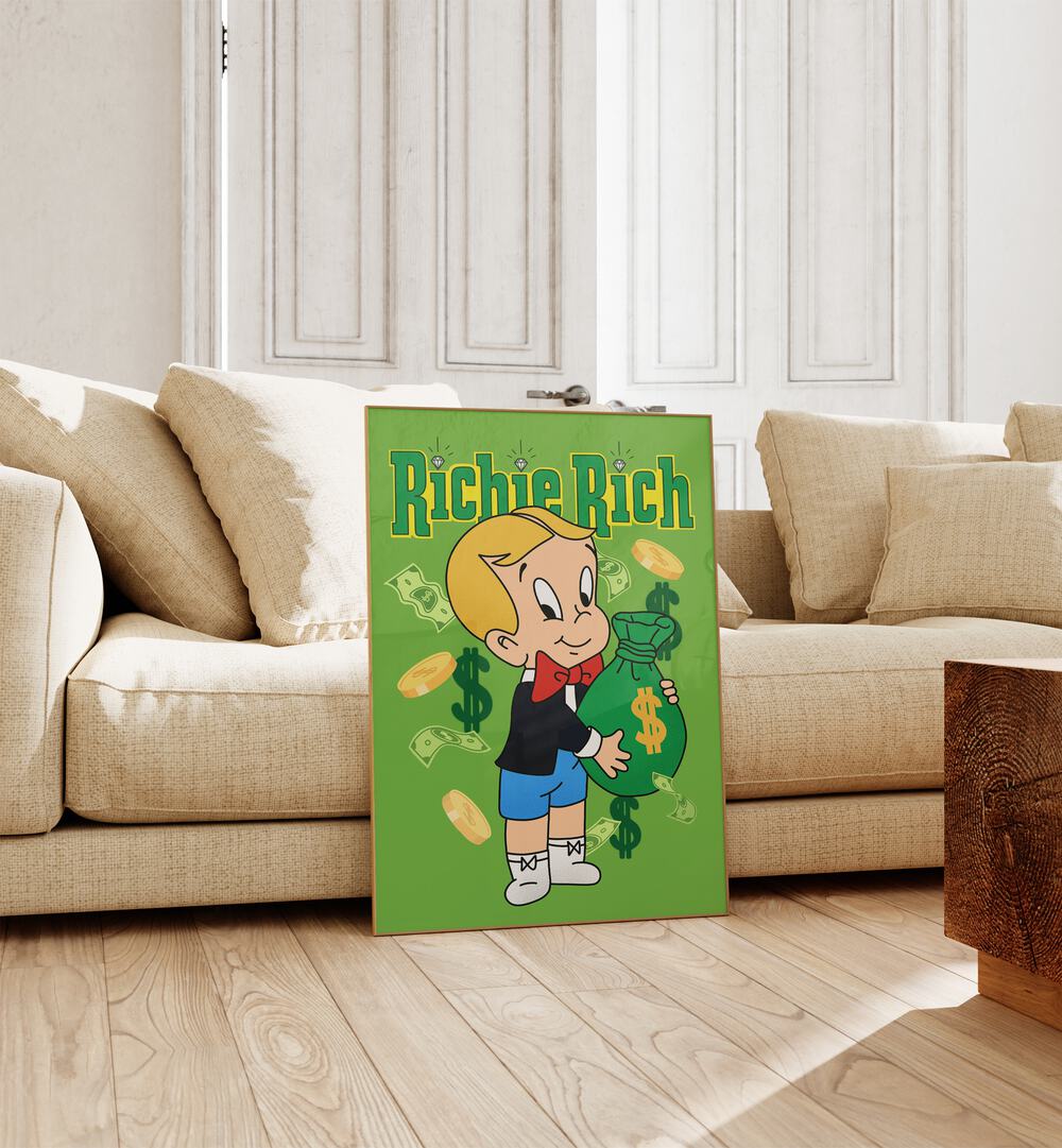 Riche Rich Comic Wall Art Comic Posters in Oak Wood Plain Frame placed on the floor near a Beige Sofa in the Living Room