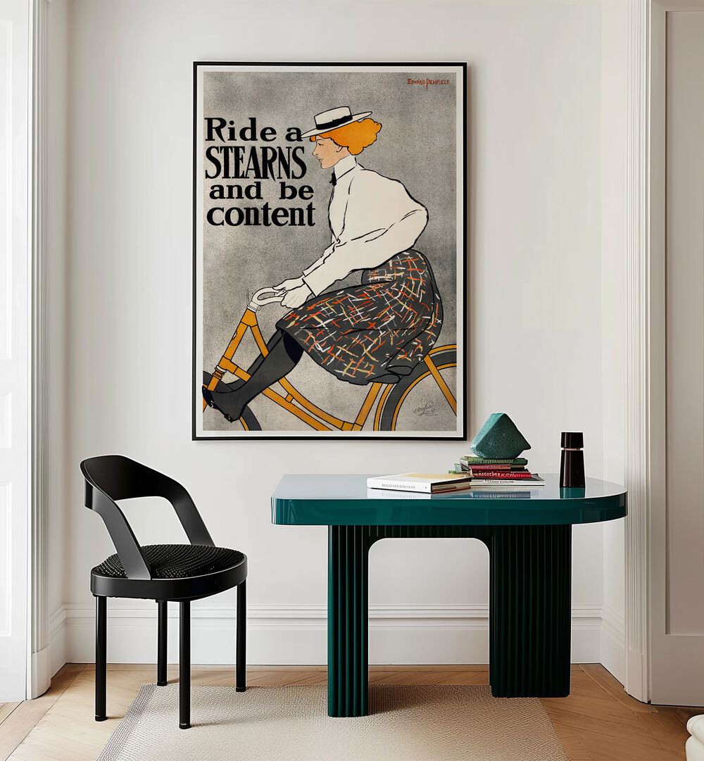 Ride A Stearns And Be Content 1896 Vintage Paintings in Black Plain Frame placed on a wall behind a study table