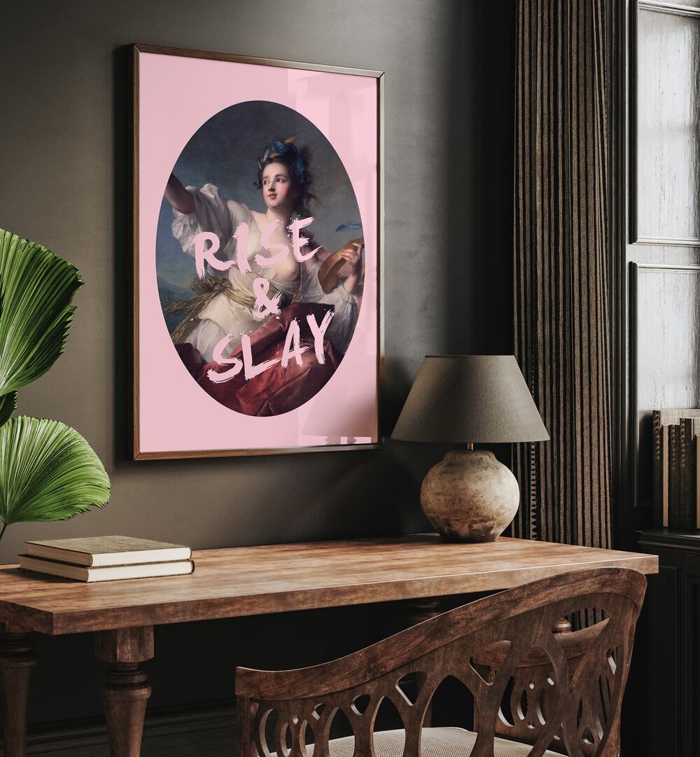 Rise and Slay By Grace Digital Art Co Altered Art Prints in Dark Wood Plain Frame placed on a wall behind a study table