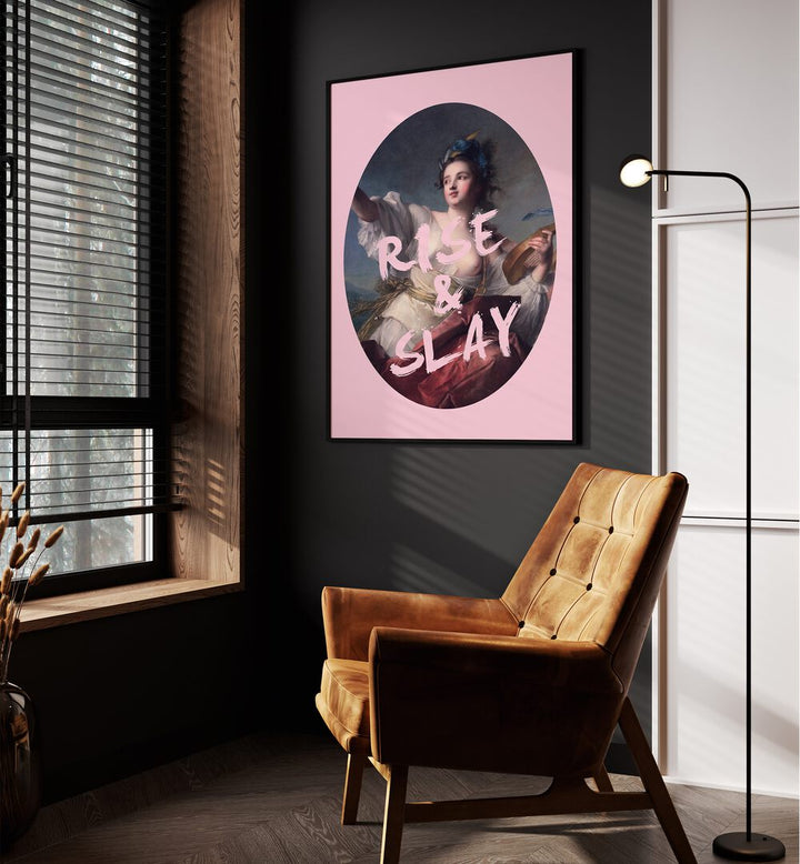 Rise and Slay By Grace Digital Art Co Altered Art Prints in Black Plain Frame placed on a wall beside an orange sofa