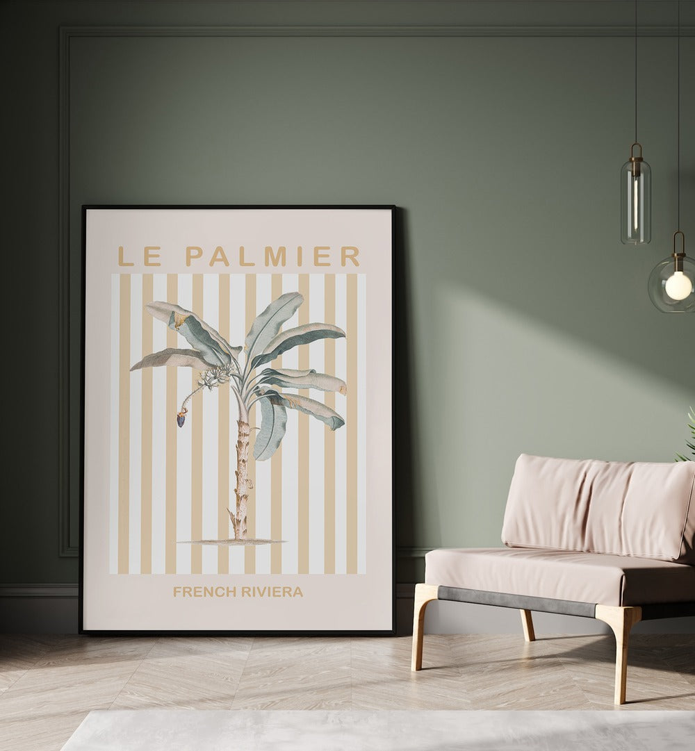 Riviera Plam Tree By Grace Digital Art Co Beach Prints in Black Plain Frame placed on a floor beside a sofa