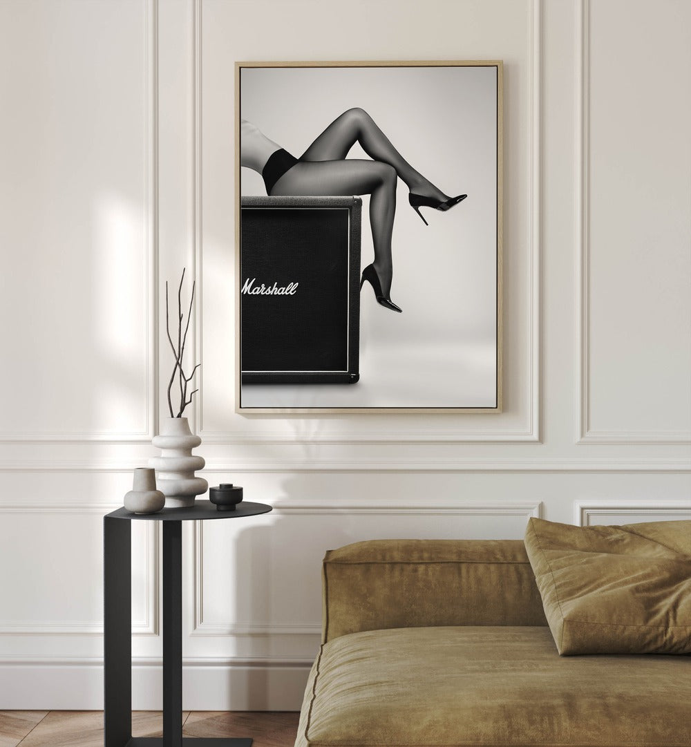 Rock N Legs by David Drake Fine Art Photography Fashion Photography in Oak Wood Floater Frame placed on a white wall behind a sofa and a table